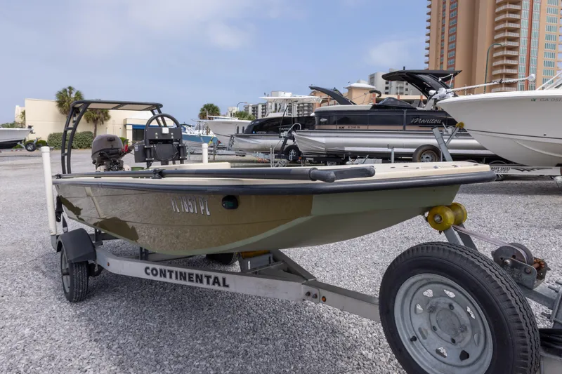 Slide: The Image of 2016 Salt Marsh 1444 boat on Continental trailer in marina parking lot. - 5