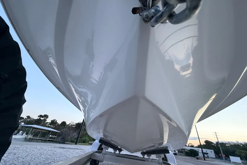 Slide: The Image of 2019 Mitzi Skiffs 17 boat hull on trailer, showcasing sleek design and craftsmanship. - 11