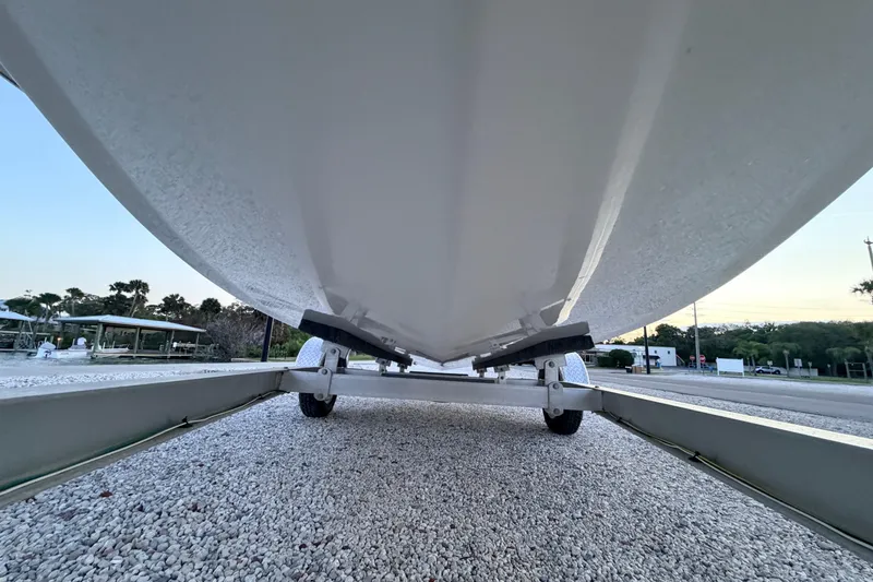 Slide: The Image of Underneath view of a 2019 Mitzi Skiffs 17 boat on a trailer. - 12