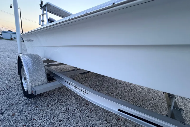 Slide: The Image of 2019 Mitzi Skiffs 17 boat on trailer, side view, parked on gravel. - 15