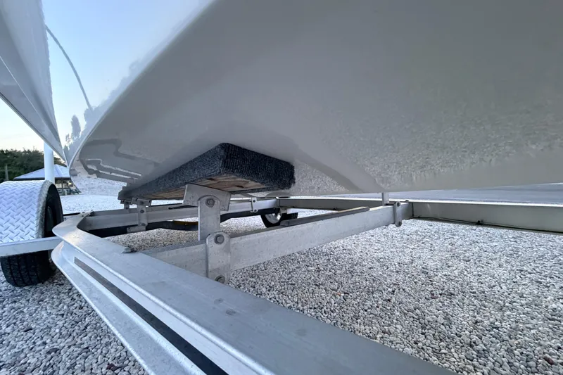 Slide: The Image of 2019 Mitzi Skiffs 17 boat on trailer, showing hull and support structure. - 16
