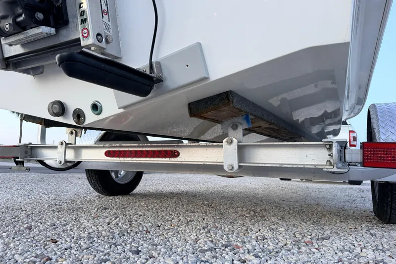 Slide: The Image of Trailer view of a 2019 Mitzi Skiffs 17 boat on gravel surface. - 20