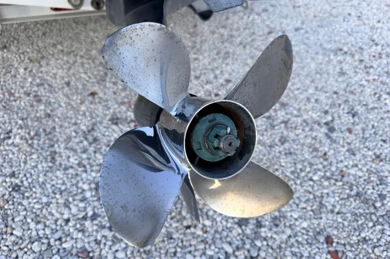 Slide: The Image of Propeller of a 2019 Mitzi Skiffs 17 boat on gravel surface. - 26