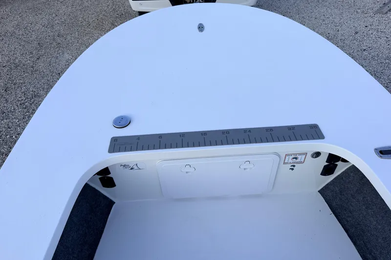Slide: The Image of 2019 Mitzi Skiffs 17 boat deck with measurement ruler and storage compartment. - 30