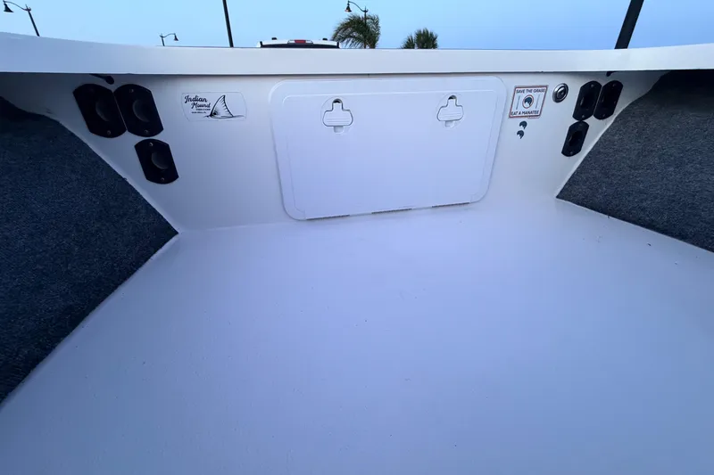Slide: The Image of Interior view of a 2019 Mitzi Skiffs 17 boat, featuring storage compartments and speakers. - 31