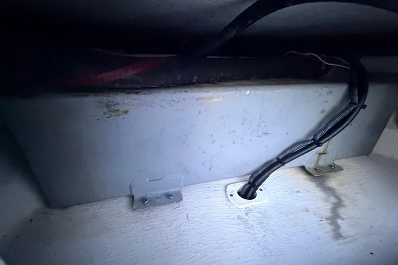Slide: The Image of Interior view of a 2019 Mitzi Skiffs 17 boat, showing wiring and compartment details. - 33