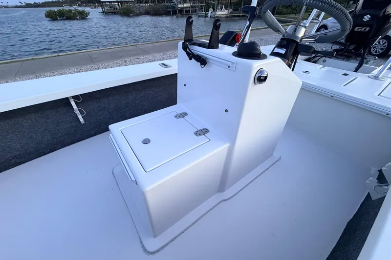Slide: The Image of 2019 Mitzi Skiffs 17 boat interior with console and storage, near waterfront. - 34