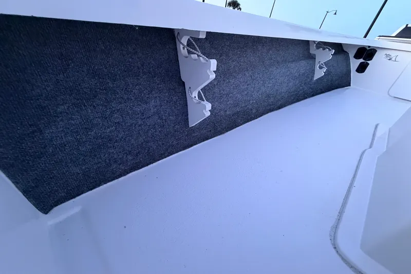 Slide: The Image of Interior view of a 2019 Mitzi Skiffs 17 boat, featuring carpeted side panels. - 39