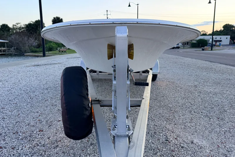 Slide: The Image of Front view of a 2019 Mitzi Skiffs 17 boat on a trailer, parked on gravel. - 4