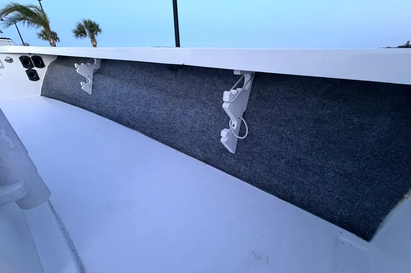 Slide: The Image of Interior view of a 2019 Mitzi Skiffs 17 boat with rod holders and carpeted side panel. - 40