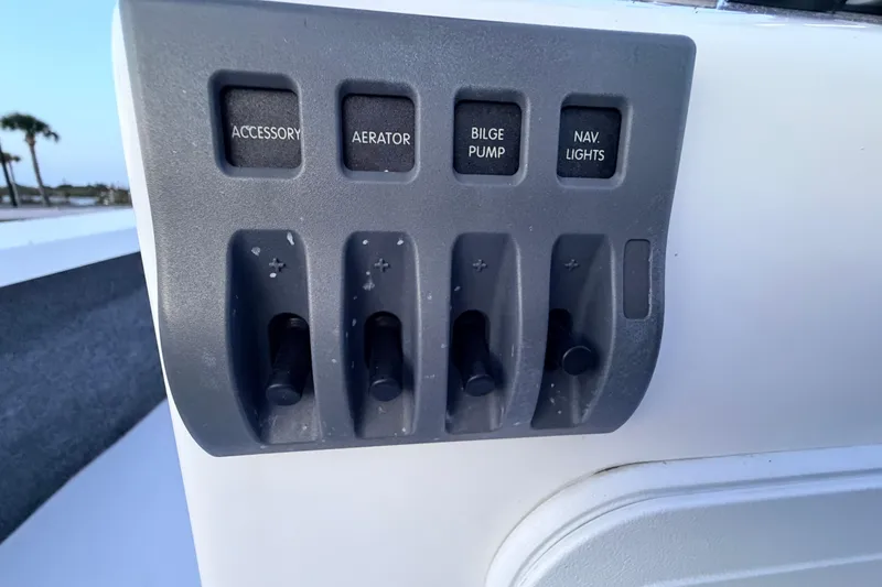 Slide: The Image of Control panel of a 2019 Mitzi Skiffs 17 boat with accessory switches. - 42