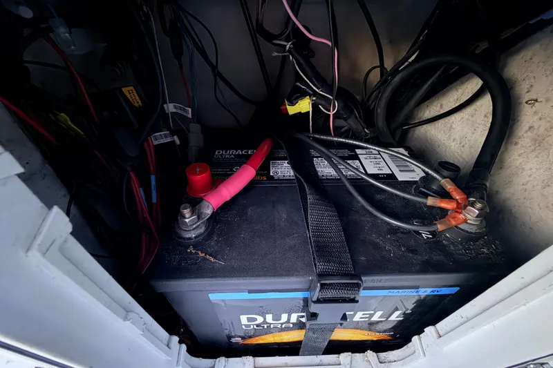 Slide: The Image of Battery compartment of a 2019 Mitzi Skiffs 17 boat with wiring connections. - 44