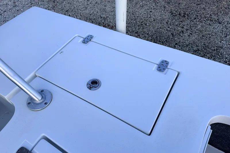 Slide: The Image of 2019 Mitzi Skiffs 17 boat deck with storage hatch and metal pole. - 56
