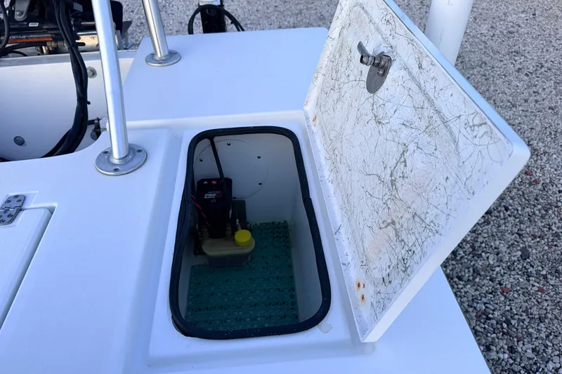 Slide: The Image of Open storage compartment on a 2019 Mitzi Skiffs 17 boat, showing interior details. - 57