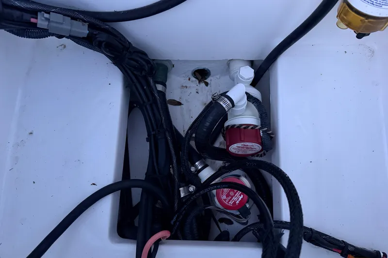 Slide: The Image of Bilge area of 2019 Mitzi Skiffs 17 with wiring and pump components. - 64