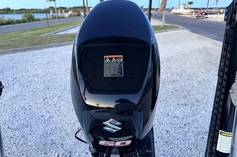 Slide: The Image of Outboard motor on a 2019 Mitzi Skiffs 17, parked near a waterfront. - 67