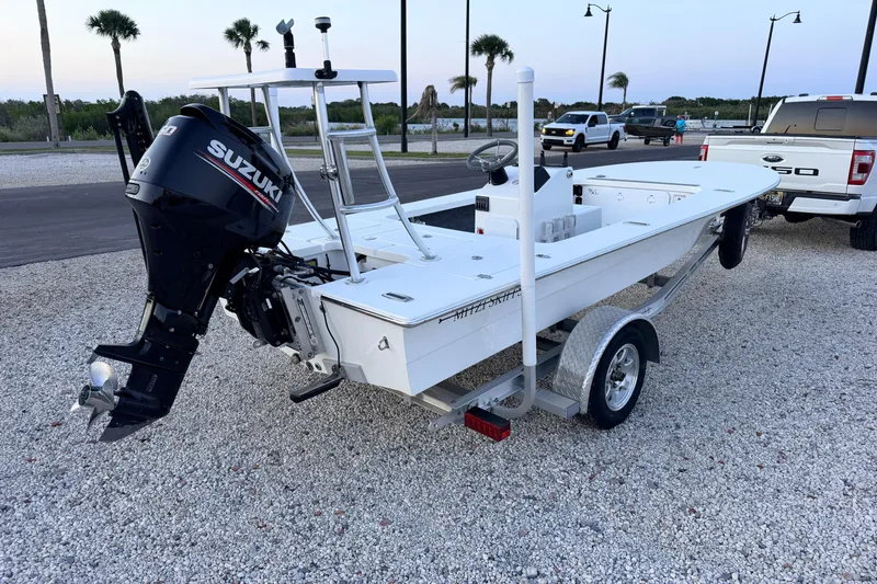 Slide: The Image of 2019 Mitzi Skiffs 17 boat with Suzuki outboard motor on a trailer, parked on gravel. - 7
