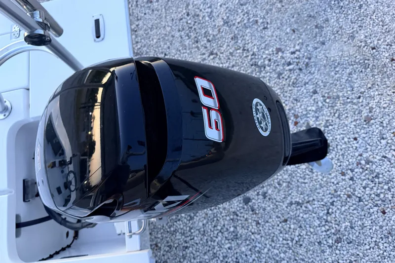 Slide: The Image of Outboard motor on a 2019 Mitzi Skiffs 17 boat, gravel background. - 71