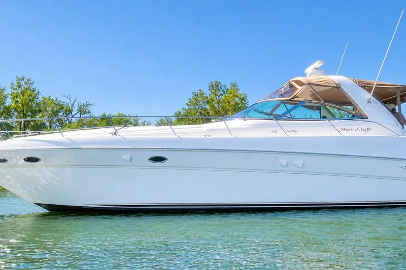 The Image of 1999 Sea Ray Sundancer 460 yacht on calm water, clear sky background. - 1