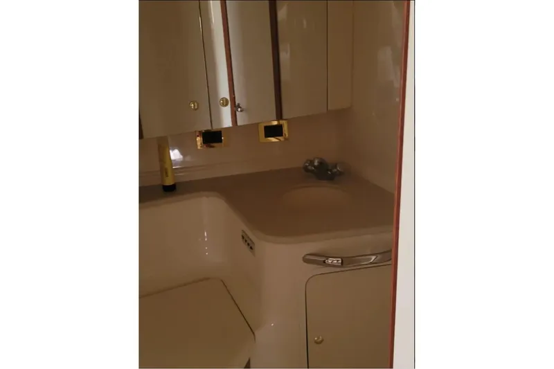 Slide: The Image of Bathroom interior of 1999 Sea Ray Sundancer 460 yacht, featuring sink and storage cabinets. - 11