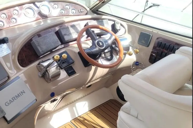Slide: The Image of Cockpit of 1999 Sea Ray Sundancer 460 with Garmin navigation system and wooden steering wheel. - 4