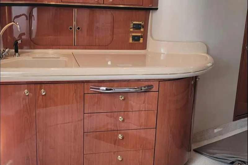 Slide: The Image of Luxurious wooden cabinetry and sink in 1999 Sea Ray Sundancer 460 yacht interior. - 7