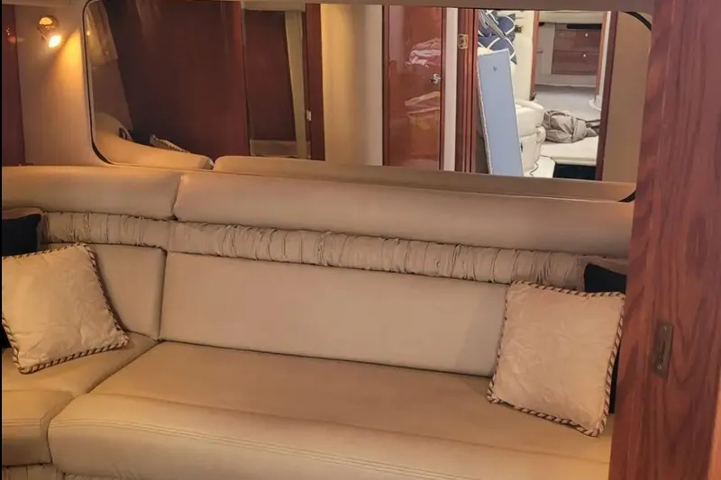 Slide: The Image of Interior of 1999 Sea Ray Sundancer 460 yacht with beige seating and decorative pillows. - 8