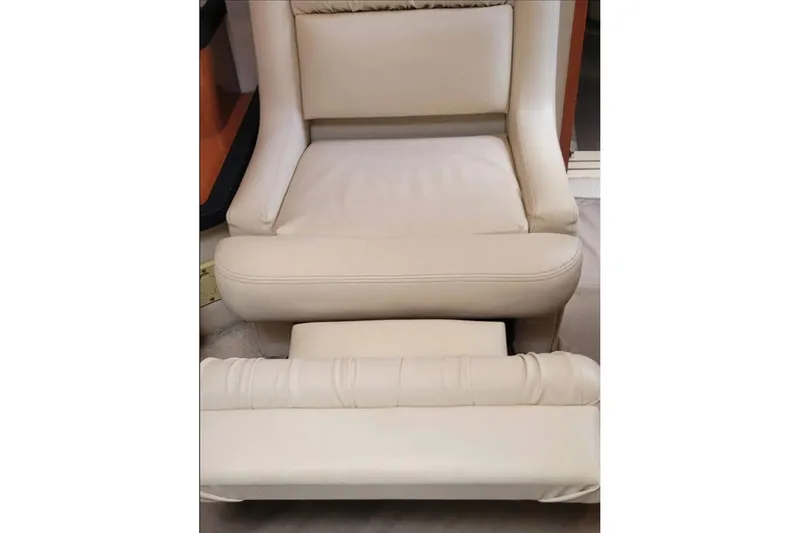 Slide: The Image of Cream leather seat with footrest on 1999 Sea Ray Sundancer 460 yacht. - 9