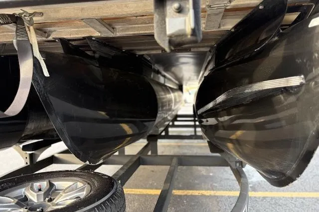 Slide: The Image of Underneath view of a 2024 Regency 250 DL3 pontoon boat on a trailer. - 12