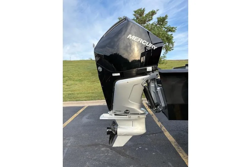Slide: The Image of 2024 Regency 250 DL3 boat with Mercury outboard motor in parking lot. - 14