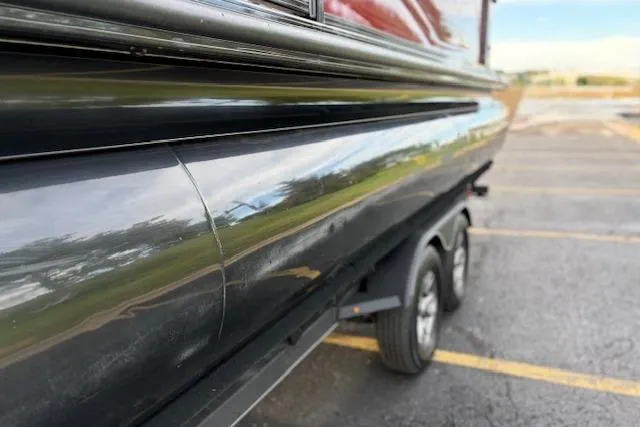 Slide: The Image of 2024 Regency 250 DL3 pontoon boat on trailer, close-up side view. - 18