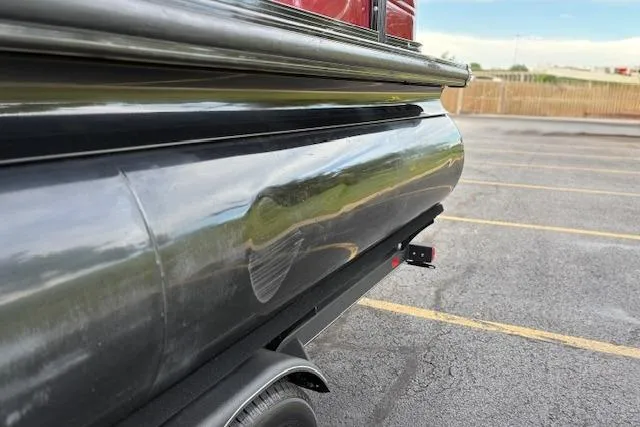 Slide: The Image of 2024 Regency 250 DL3 pontoon boat on trailer in parking lot. - 19