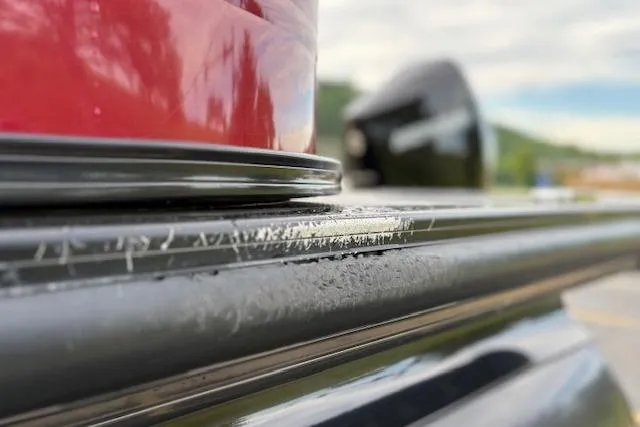 Slide: The Image of Close-up of 2024 Regency 250 DL3 boat detail with red and black elements. - 21