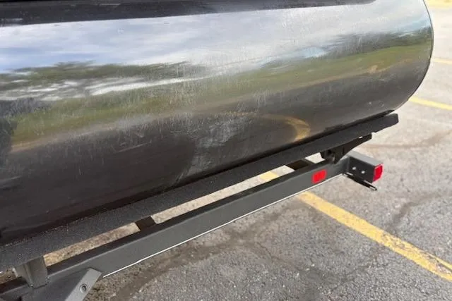 Slide: The Image of Close-up of a 2024 Regency 250 DL3 pontoon boat on a trailer. - 22