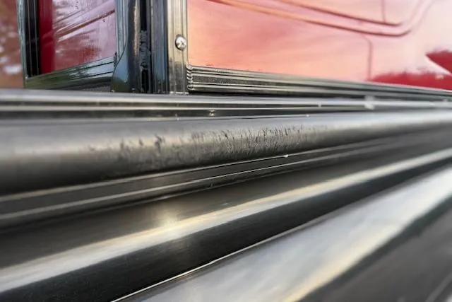 Slide: The Image of Close-up of 2024 Regency 250 DL3 exterior detailing with red and black trim. - 25