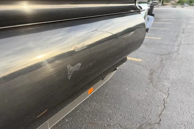 Slide: The Image of Close-up of a 2024 Regency 250 DL3 boat hull with minor scratch. - 26