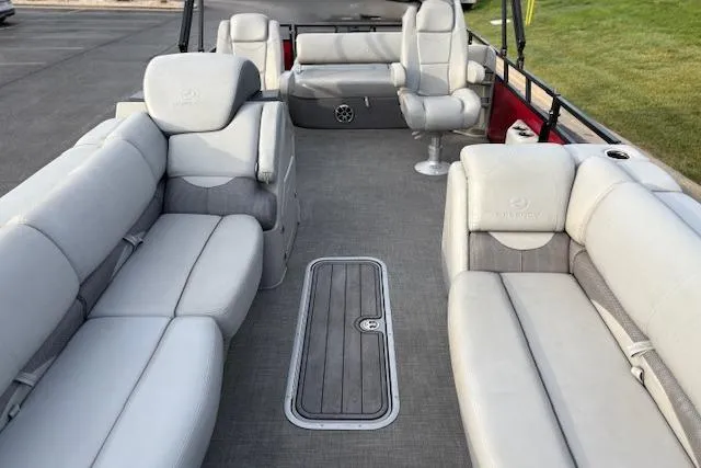 Slide: The Image of Luxurious 2024 Regency 250 DL3 pontoon boat interior with plush seating and spacious layout. - 31