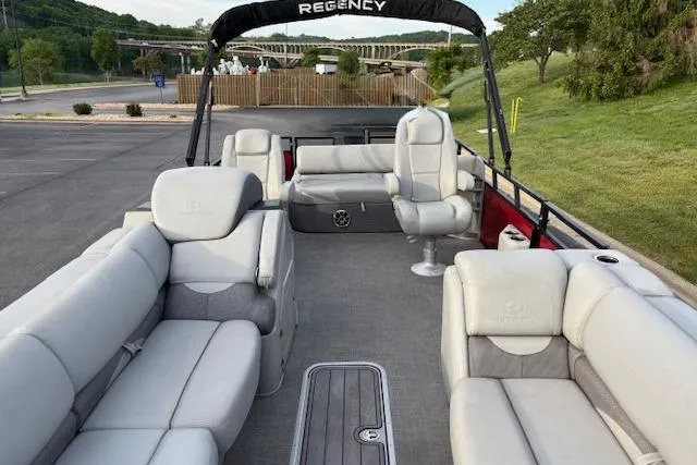 Slide: The Image of 2024 Regency 250 DL3 pontoon boat with spacious seating and modern design. - 32