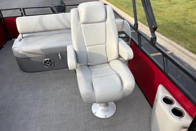 Slide: The Image of 2024 Regency 250 DL3 boat interior with plush seating and cup holders. - 33