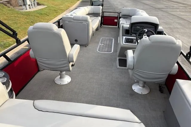 Slide: The Image of 2024 Regency 250 DL3 pontoon boat interior with gray seating and steering console. - 37