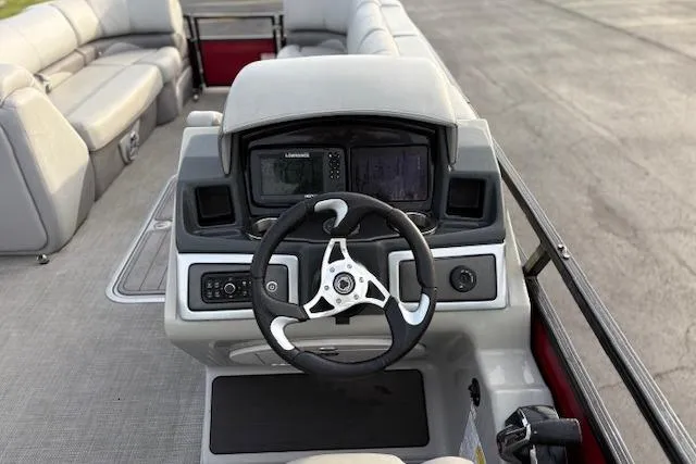 Slide: The Image of 2024 Regency 250 DL3 boat dashboard with steering wheel and navigation system. - 38