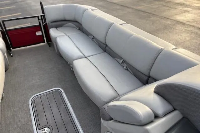 Slide: The Image of 2024 Regency 250 DL3 pontoon boat with spacious gray seating and sleek flooring. - 39