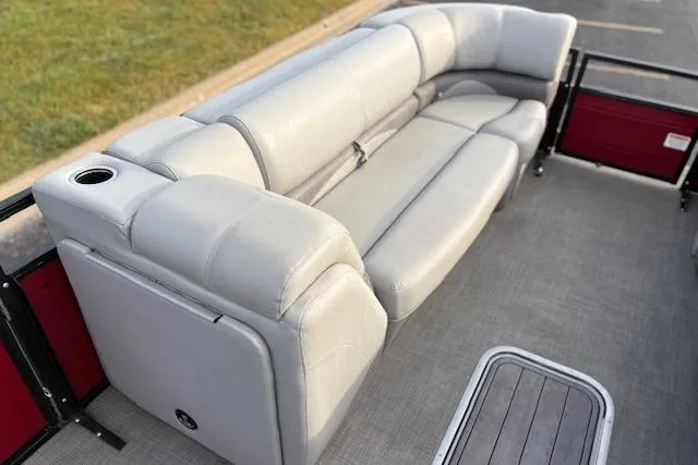 Slide: The Image of 2024 Regency 250 DL3 pontoon boat with luxurious gray seating and cup holder. - 40