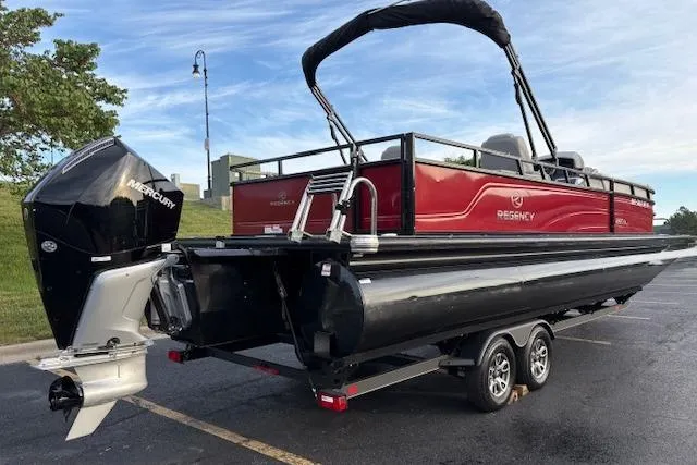 Slide: The Image of 2024 Regency 250 DL3 pontoon boat with Mercury engine on a trailer. - 5