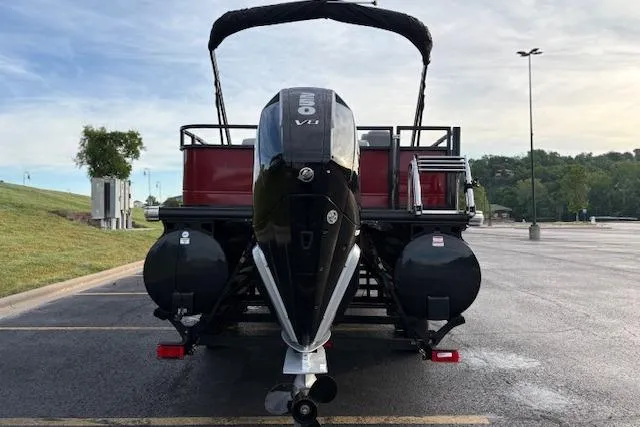 Slide: The Image of 2024 Regency 250 DL3 pontoon boat with powerful V8 engine in a parking lot. - 6