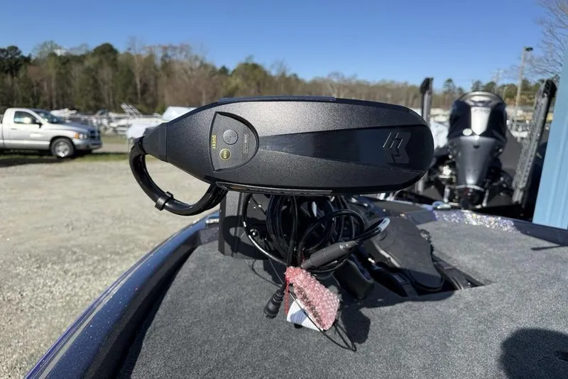 Slide: The Image of 2026 Skeeter ZXE21 boat control panel with buttons, outdoors in a parking area. - 9