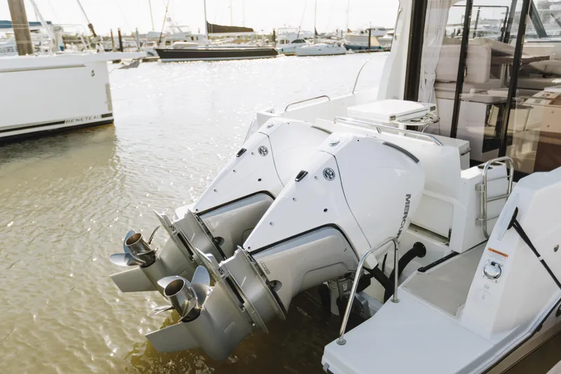 Slide: The Image of Twin Mercury outboard engines on a 2026 Beneteau Antares 9, docked at a marina. - 11