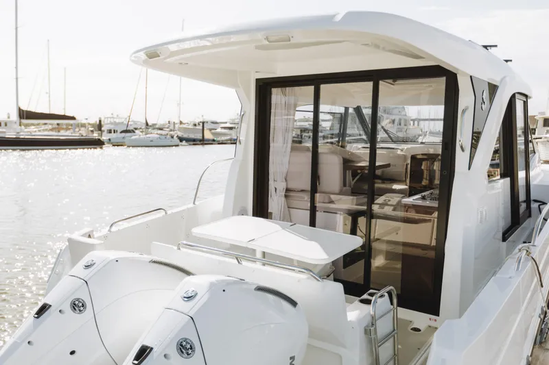 Slide: The Image of 2026 Beneteau Antares 9 boat with dual engines, docked in a marina. - 3