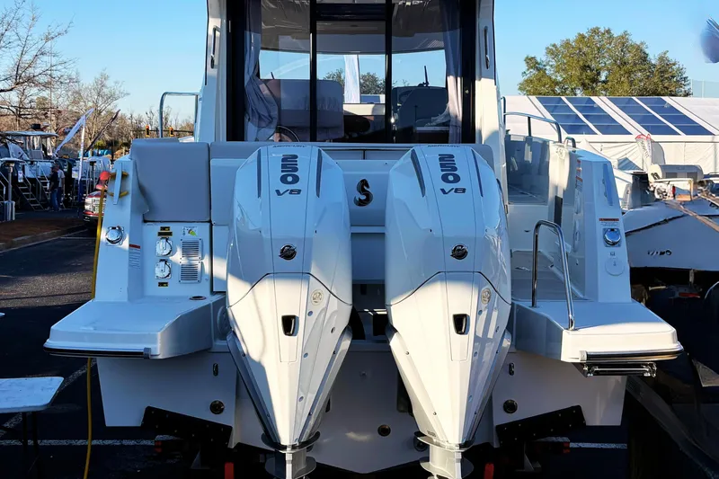 Slide: The Image of 2026 Beneteau Antares 9 with twin 250 V8 engines, rear view at a boat show. - 4