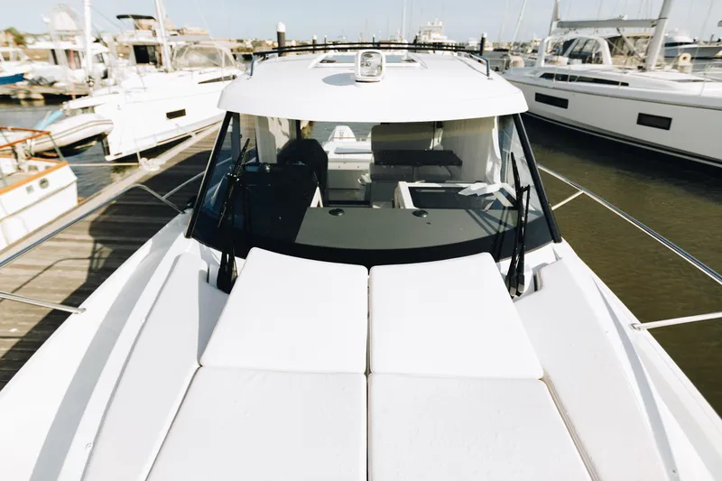 Slide: The Image of 2026 Beneteau Antares 9 yacht docked at marina, showcasing sleek design and spacious deck. - 9
